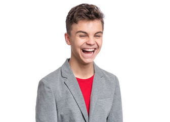 Handsome Teen Boy in gray suit. Portrait of caucasian Smiling Teenager isolated on white...