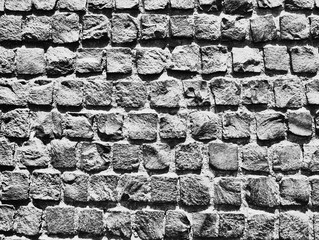 Old paving stones closeup. Black and white background.