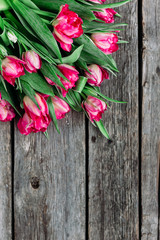 Fototapeta na wymiar Spring Bouquet of pink peony tulips on a wooden background with space for text.