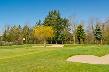 Golf place with gorgeous green and sand bunker.