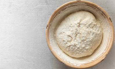 .The process of raising the dough in a special basket. Dough made from natural sourdough. Wheat dough. Fermentation.