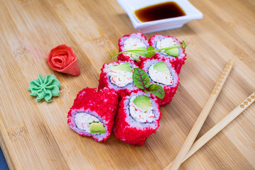 Japanese sushi food on a wooden Board. salmon, rice, wasabi, ginger, chopsticks Hashi Japanese cuisine