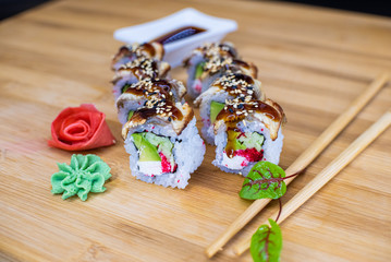 Japanese sushi food on a wooden Board. salmon, rice, wasabi, ginger, chopsticks Hashi Japanese cuisine