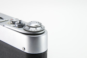 Old film retro camera. Shutter and trigger (button) close-up. Metallic black. White isolated background.