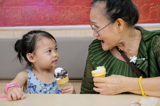 Grand mother and nephew having icream