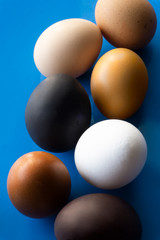 seven multi-colored eggs lie on the table