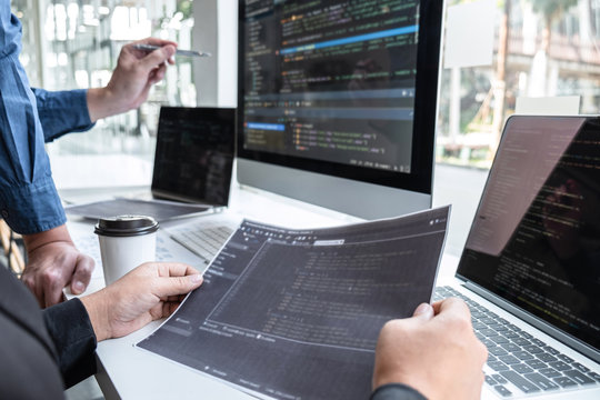 Team of developer programmer working on project in software development computer in IT company office, Writing codes and data code website and coding database technologies to find problem solution