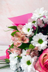 A bouquet of blooming delicate flowers, a festive pink background, a delicate pastel bouquet, a floral card, for March 8.