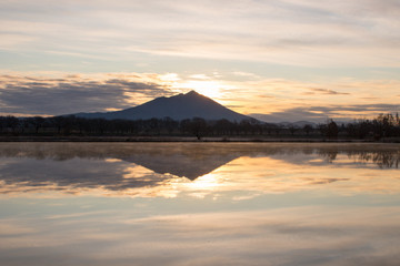 Mount Tsukuba and the morning glow sky and their reflection on the lake surface