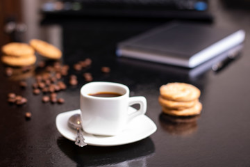 Banana oatmeal cookies with chocolate spread and mug of coffee in office