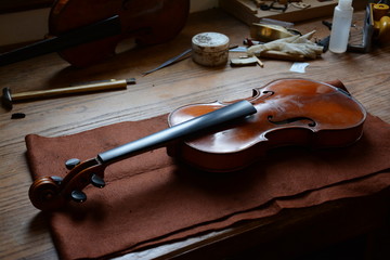 Fototapeta premium Detail of work table of luthier with old violin in Spain