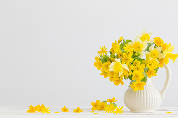 Still life with yellow spring flowers in jug