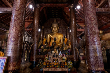 Buddha statues in Wat Xieng Thong in Luang Prabang , Laos - 323763316