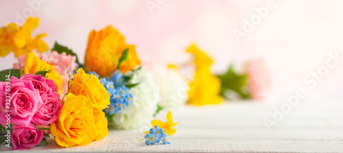 Beautiful spring flowers on white wooden table. Festive concept with copy space.