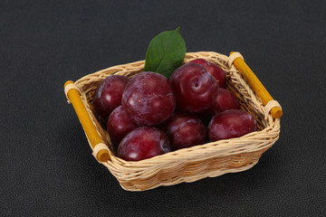 Plum heap in the wooden basket