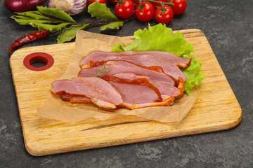 Sliced smoked duck breast served salad