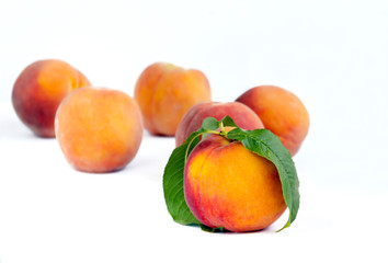 peaches fruits with red sides in a slide on a light background