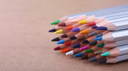Obraz premium Color pencils on cardboard background