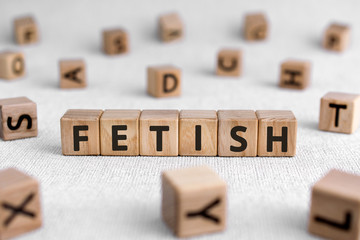 Fetish - words from wooden blocks with letters, worshiped object   fetish concept, white background - obrazy, fototapety, plakaty