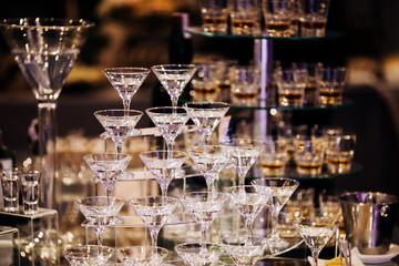 Fototapeta na wymiar Pyramid of martinis glasses on a cocktail reception on wedding party