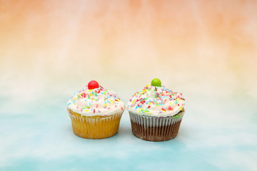 Delicious cute and sweet cup cake decorated with cream for Birthday party on the table 