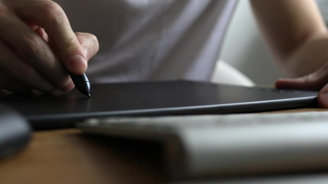 Graphic Designer or photographer working with digital Drawing tablet and Pen on a computer