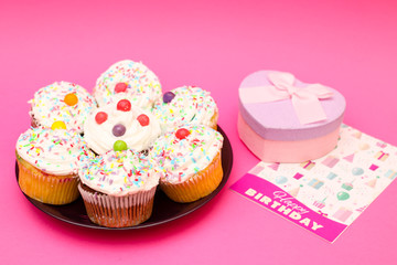 Delicious cute and sweet cup cake decorated with cream for Birthday party on the table 