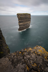 Seascape at downpatrick head in ireland during grey cloudy day sky