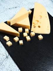 Pieces of cheese on a dark background.