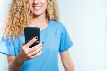 Fototapeta premium Closeup of nurse holding a mobile phone