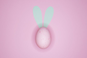 Happy Easter background, with a pink egg with rabbit ears.