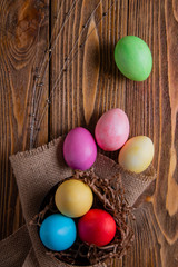 Easter Composition. Colored eggs on a napkin from on a wooden table.