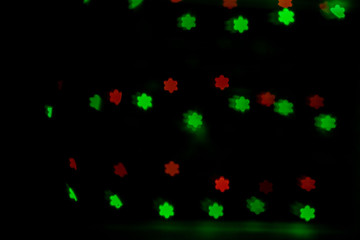 Bokeh in the form of snowflakes of red and green