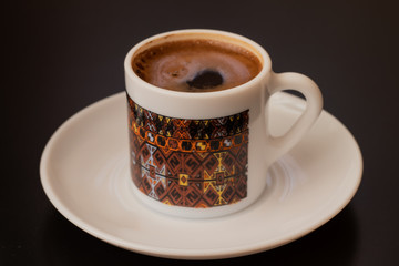 Foamy Turkish coffee in the little coffee cup