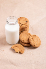 Oat flakes in bottle of milk on paper background. oatmeal cookies for breakfast