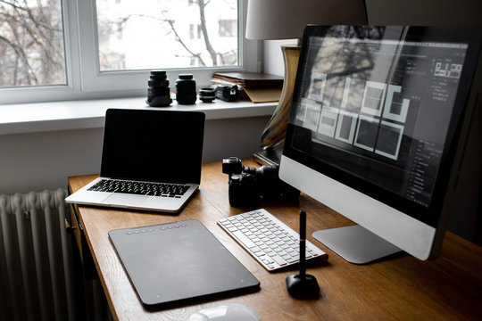 Stylish workspace with laptop on home or studio. photographer's workplace
