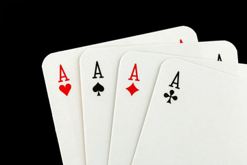 Four aces on black background