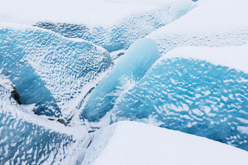 Fototapeta na wymiar Mountains with clouds on Antarctica. Glaciers, icebergs and ice caves of Southern hemisphere. Global climate change on Earth. Importance of ecological balance on the planet. Landscape with blue ice.
