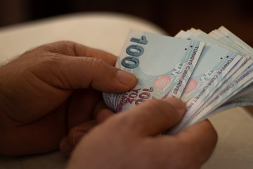 The man is counting Turkish liras, home economy, economic crisis in Turkey, Turkish currency