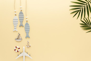 Holidays Travel. Palm leaf fish plane summer background with copy space for your text. Flat lay, top view.