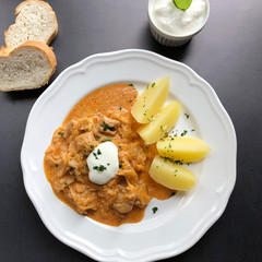 Hungarian Szeged goulash with with sour cabbage and boiled potatoes.