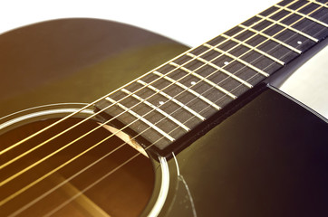 Obraz premium part of an acoustic guitar on white. Close-up. Image is tinted.