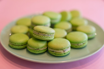 Green sweet macaroons on the plate