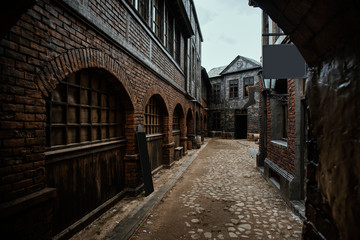 Fototapeta na wymiar Old vintage brick buildings in the village on a grey cloudy day