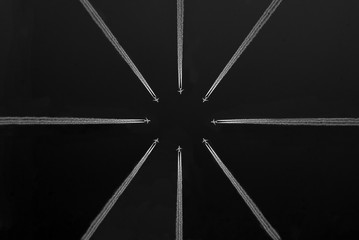 Eight airplanes with white trails, in circle shape, black and white