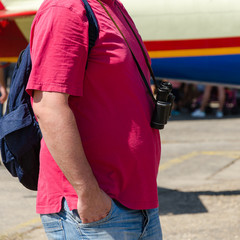 Senior man with binoculars hanging around his neck