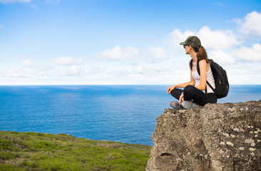 Female hiker sitting relaxing enjoying the ocean view 