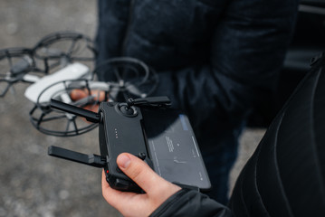 Young people are preparing a drone for flight. Drone setup.