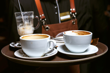 Used coffee cups on a tray