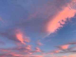 Fototapeta na wymiar Tender pink clouds in the blue sky, natural colors
